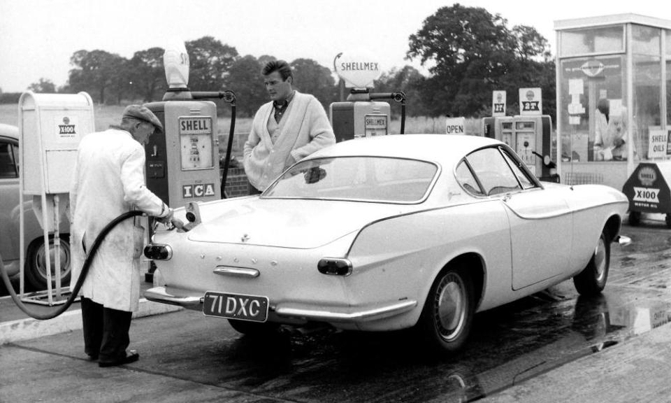 Roger Moore, star of The Saint with his Volvo, circa, 1967.