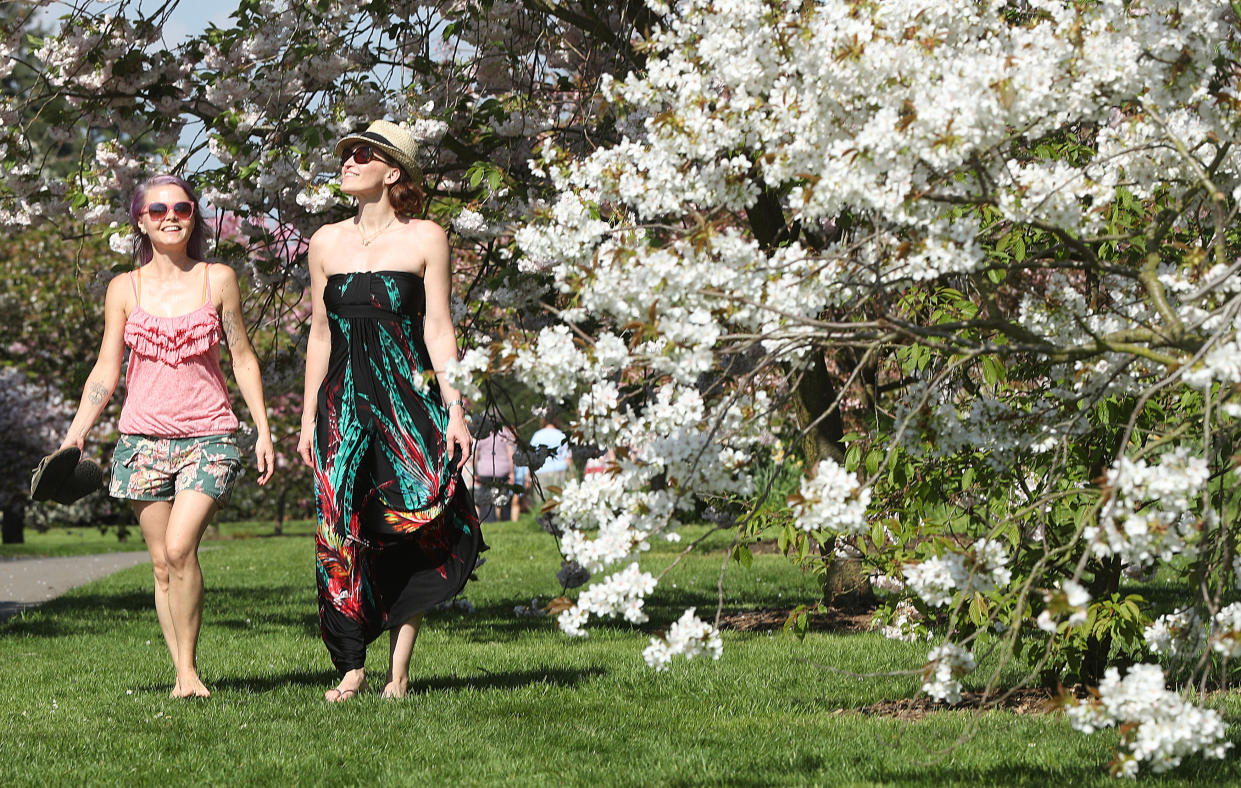 Two women enjoy the sunshine (PA)