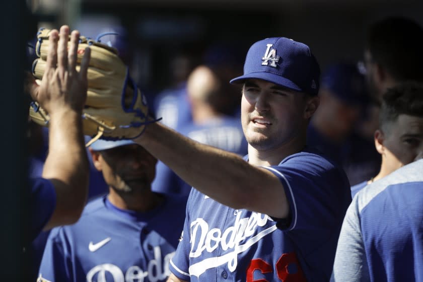Los Angeles Dodgers starting pitcher Ross Stripling is greeted in the dugout.