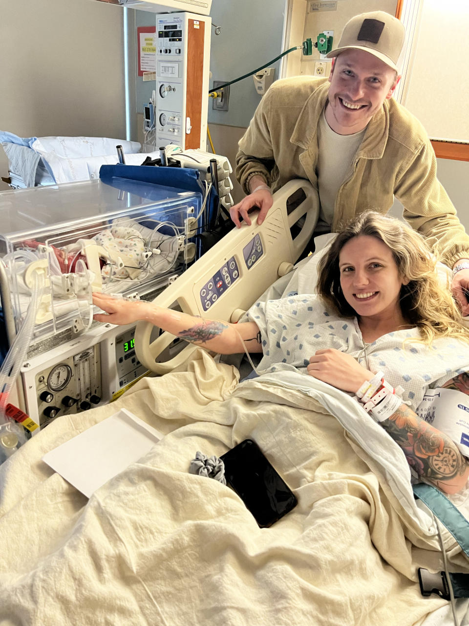 Meghan Huston and her husband, visiting one of her newborn twin sons shortly after giving birth. (Courtesy Meghan Huston)