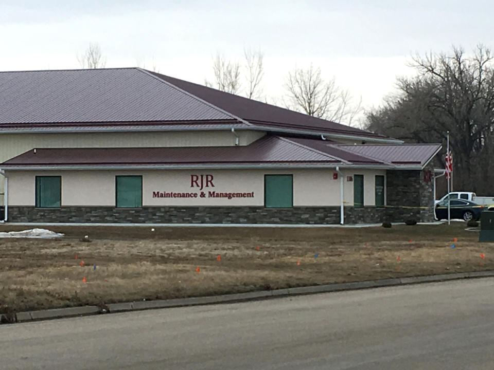 Cars are parked outside RJR Maintenance and Management in Mandan, N.D., on Monday, April 1, 2019. Police in North Dakota say "several" bodies have been found inside the business in suburban Bismarck. (Mike McCleary/The Bismarck Tribune via AP)