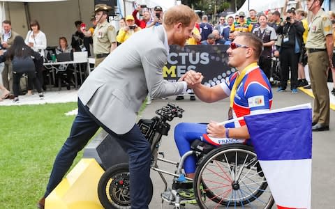 Prince Harry, Duke of Sussex shaking hands with french competitor during day two of the Invictus Games in Sydney - Credit: Chris Jackson/Getty Images