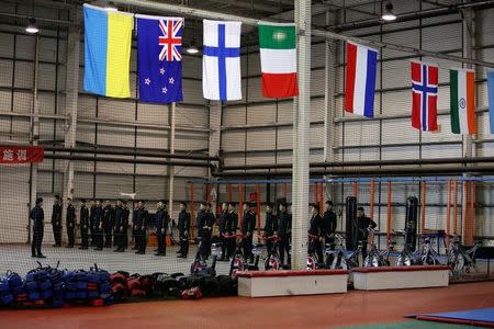 Trainees from Dewei Security attend a daily training session at a training camp, on the outskirts of Beijing, China March 2, 2017. Picture taken March 2, 2017. To match Analysis CHINA-SILKROAD/SECURITY REUTERS/Jason Lee