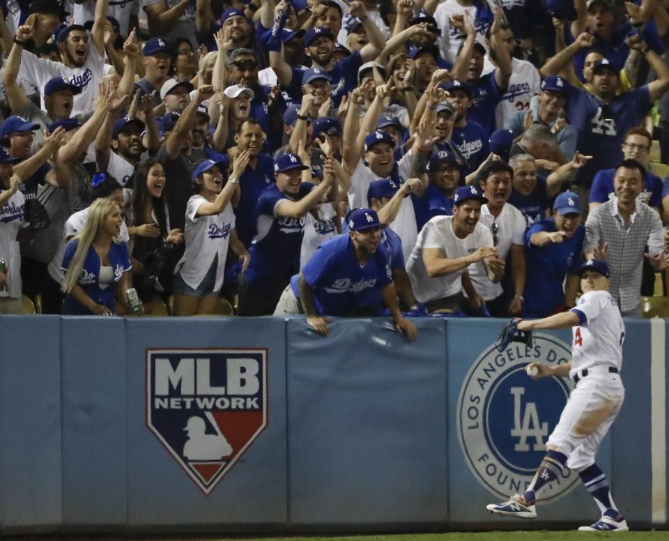 <p>Fans cheer as Los Angeles Dodgers’ Enrique Hernandez catches a long fly ball hit by Houston Astros’ Josh Reddick during the eighth inning of Game 1 of baseball’s World Series Tuesday, Oct. 24, 2017, in Los Angeles. (AP Photo/David J. Phillip) </p>