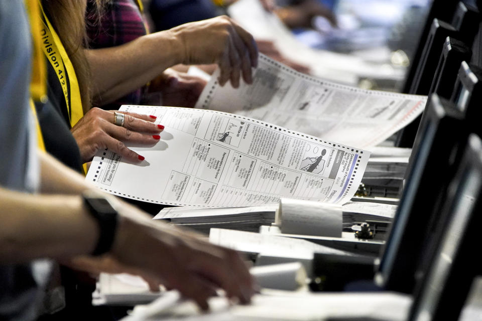 FILE – Election workers at the Allegheny County Election Division warehouse in Pittsburgh process ballots from the 2022 Pennsylvania primary on June 1, 2022. Threatening letters sent to local election offices in at least five states, some including fentanyl, are the latest concern for local election workers around the country, who have faced harassment and even death threats since the 2020 presidential election. (AP Photo/Gene J. Puskar, File)