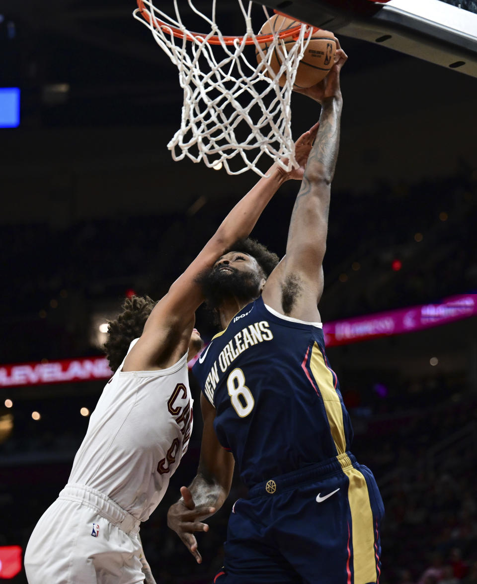 New Orleans Pelicans forward Naji Marshall dunks against Cleveland Cavaliers guard Craig Porter during the second half of an NBA basketball game Thursday, Dec. 21, 2023, in Cleveland. The Pelicans won 123-104. (AP Photo/David Dermer)