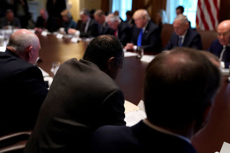 Secretary of Housing and Urban Development (HUD) Ben Carson (bottom center) leads U.S. President Donald Trump and his cabinet in prayer before a meeting at the White House in Washington, U.S., December 20, 2017. REUTERS/Jonathan Ernst