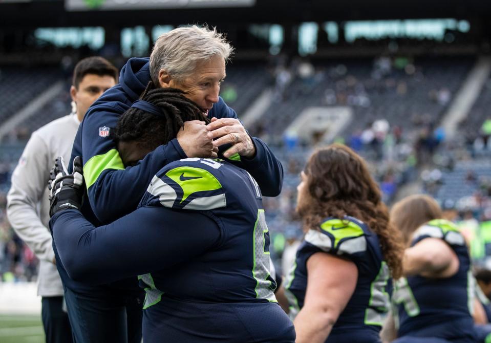 SEATTLE, WA - DECEMBER 22: Seattle Seahawks head coach Pete Carroll hugs offensive lineman Germain Ifedi #65 of the Seattle Seahawks during warmups before a game against the Arizona Cardinals at CenturyLink Field on December 22, 2019 in Seattle, Washington. (Photo by Stephen Brashear/Getty Images)