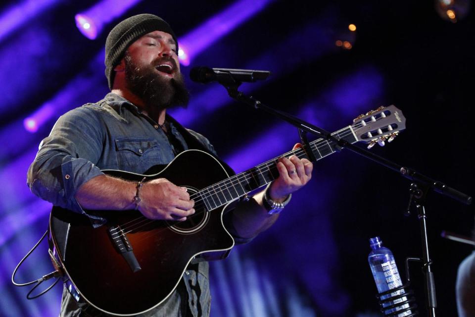 FILE - This June 6, 2013 file photo shows Zac Brown performing at the 2013 CMA Music Festival in Nashville,Tenn. When Zac Brown bumped into Dave Grohl while picking up some altered clothes for the Grammy Awards, he didn't let the random meeting go to waste. They bonded over their love of analog recording gear and their new friendship eventually resulted in Zac Brown Band's newest release: "The Grohl Sessions Vol. 1." (Photo by Wade Payne/Invision/AP, File)