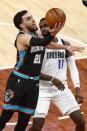 Memphis Grizzlies guard Tyus Jones (21) shoots past Dallas Mavericks forward Tim Hardaway Jr. (11) during the first half of an NBA basketball game Tuesday, May 11, 2021, in Memphis, Tenn. (AP Photo/Wade Payne)