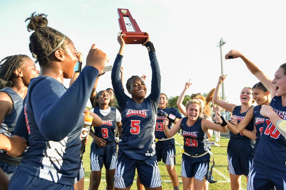 Centennial players celebrate winning the flag football District 10-2A championship against Martin County on Friday, April 23, 2021, at Martin County High School in Stuart. Centennial won 19-13 in two overtimes.
