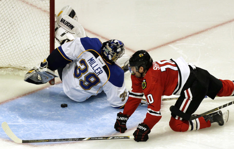 Chicago Blackhawks' Patrick Sharp (10) scores against St. Louis Blues goalie Ryan Miller (39) during the third period in Game 6 of a first-round NHL hockey playoff series in Chicago, Sunday, April 27, 2014. The Blackhawks won 5-1. (AP Photo/Nam Y. Huh)