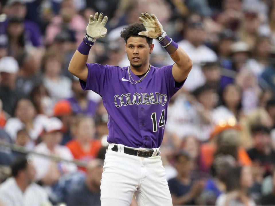 Colorado Rockies' Ezequiel Tovar gestures to the dugout after his RBI triple against the Houston Astros during the fourth inning of a baseball game Tuesday, July 18, 2023, in Denver. (AP Photo/David Zalubowski)