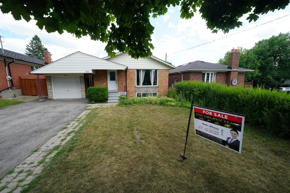 'For Sale' sign is pictured in the front yard of a house in Toronto, Ontario, Canada, July 17, 2018. Picture taken July 17, 2018. REUTERS/Carlo Allegri