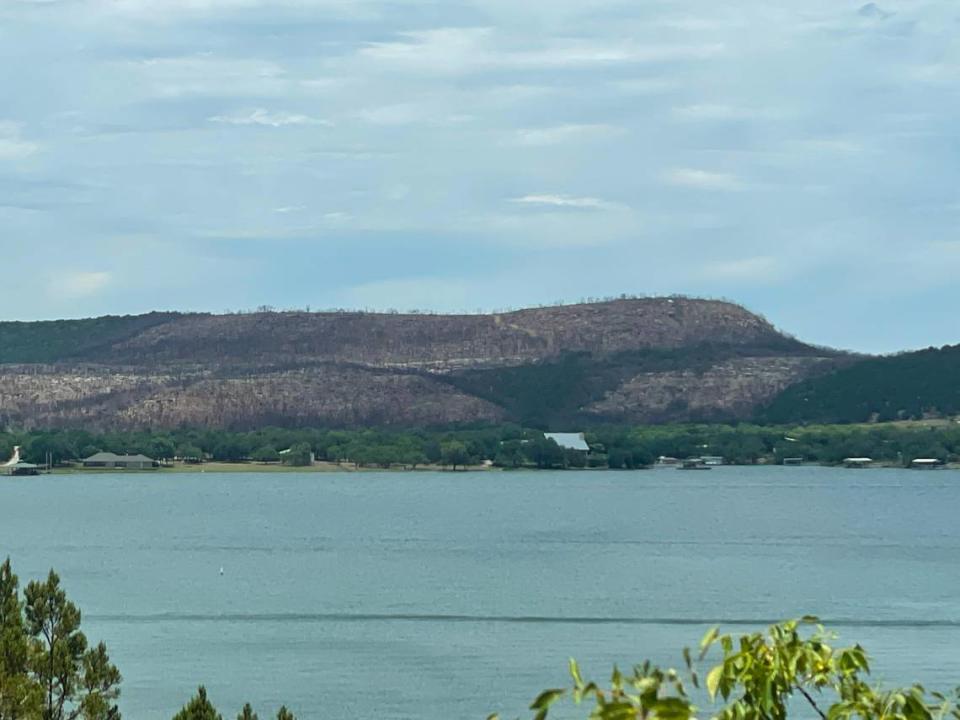 A hilltop was burned by last year’s wildfire at Possum Kingdom Lake in North Texas. A new fire covering about 1,000 acres is raging in the area on Friday, June 30, 2023.