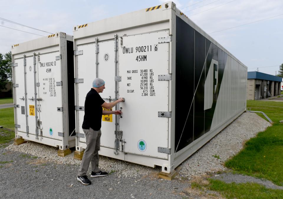 Paul Smith, owner of Next Door Harvest, grows vegetables in a 320-square-foot freight container. Water, artificial light and temperature are controlled by a laptop computer to raise produce.