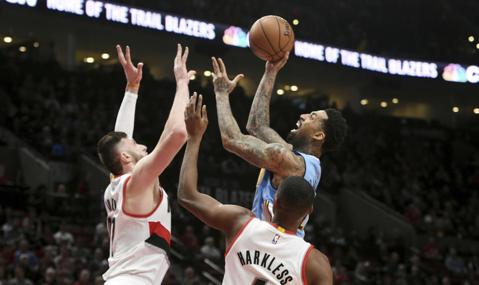 Denver Nuggets forward Wilson Chandler shoots the ball over Portland Trail Blazers center Jusuf Nurkic, left, and Portland Trail Blazers forward Maurice Harkless, right, during the first half of an NBA basketball game in Portland, Ore., Tuesday, March 28, 2017. (AP Photo/Steve Dykes)
