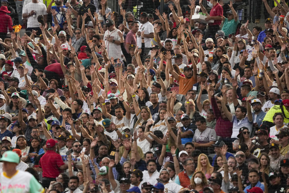 Fans cheer during an MLB baseball game between the San Diego Padres and San Francisco Giants, at the Alfredo Harp Helu Stadium in Mexico City, Saturday, April 29, 2023. (AP Photo/Fernando Llano)