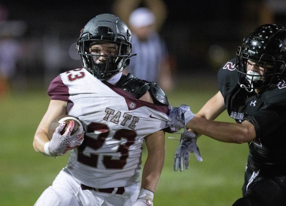 Connor Black (2) grabs ahold of Carson Secchiari (23)'s jersey to stop him during the Tate vs Navarre football game at Navarre High School on Friday, Sept. 15, 2023.