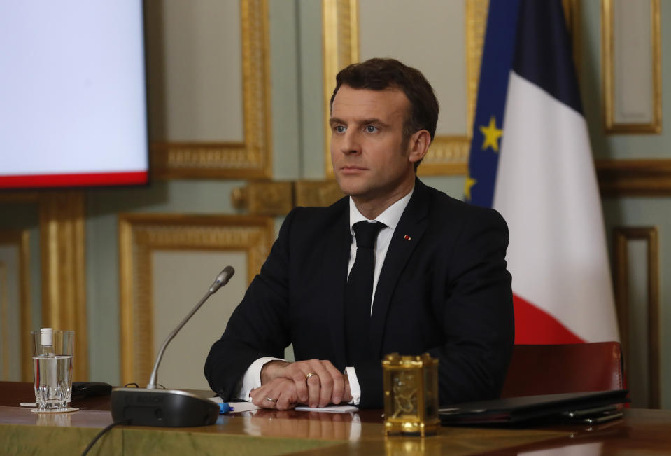 French President Emmanuel Macron listens during a G7 meeting Friday, Feb. 19, 2021 in Paris. Leaders of the Group of Seven economic powers are holding their first meeting of 2021 on Friday, and vowing to share coronavirus vaccines with the world's poorest countries — though details of how soon and how much they will give remain scarce. (AP Photo/Thibault Camus, Pool)