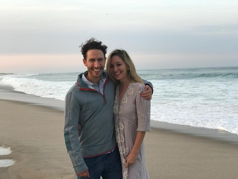 Jen Glantz and her husband standing on a beach.