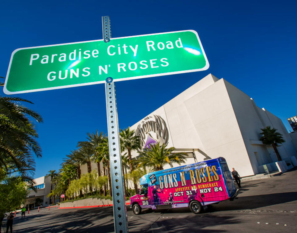 This Monday Oct. 29,2012 photo provided by Erik Kabik shows the street sign after a ceremonial street renaming of Paradise Road to Paradise City Road in Las Vegas. A county commissioner in Las Vegas says she regrets the board temporarily renamed a street in honor of Guns N' Roses after finding out about the band's suggestive publicity artwork. Ads promoting the band's four-week run at the Hard Rock Hotel & Casino depict a disheveled woman who appears to be sexually assaulted beneath the iconic "Welcome to Fabulous Las Vegas" sign. (AP Photo/Courtesy Erik Kabik)