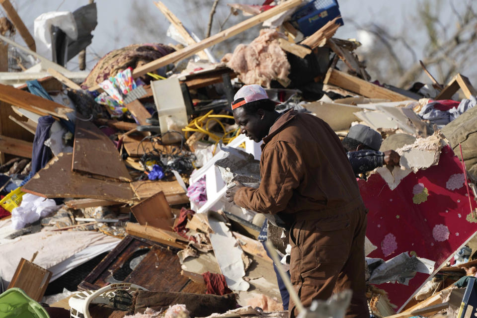 A resident looks through the piles of debris, insulation, and home furnishings to see if anything is salvageable at a tornado demolished mobile home park in Rolling Fork, Miss. March 25, 2023. Emergency officials in Mississippi say several people have been killed by tornadoes that tore through the state on Friday night, destroying buildings and knocking out power as severe weather produced hail the size of golf balls moved through several southern states. (AP Photo/Rogelio V. Solis)