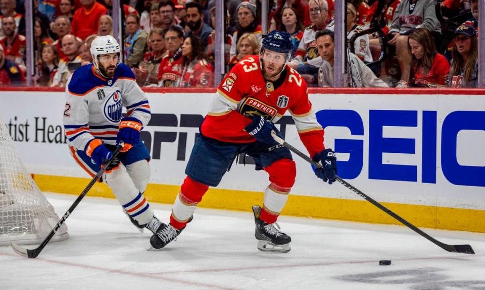 Sunrise, Florida, June 8, 2024 - Florida Panthers center Carter Verhaeghe (23), right, looks to make a pass as Edmonton Oilers defenseman Evan Bouchard (2), left defends during game 1 of the Stanley Cup Final at Amerant Arena in Sunrise, Florida.