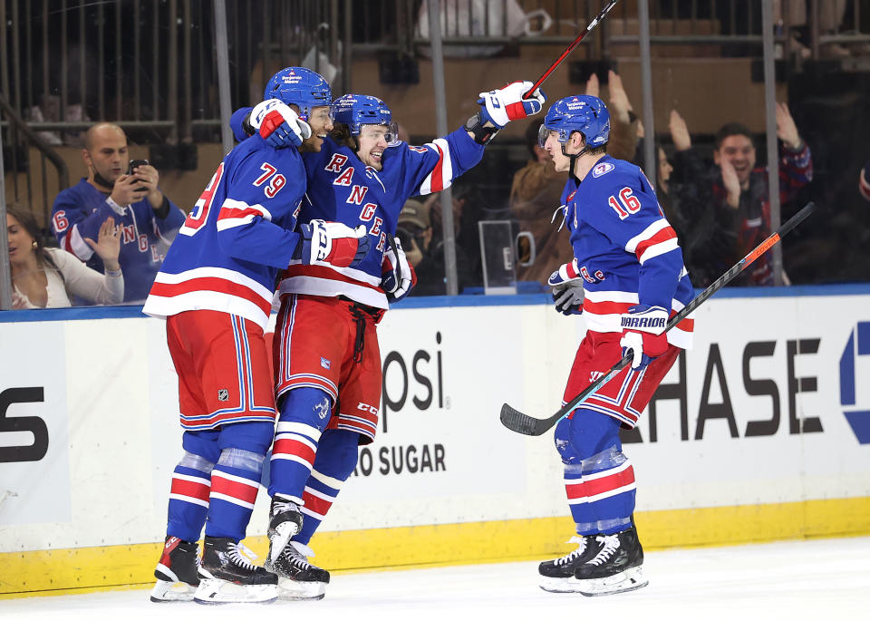 NEW YORK, NEW YORK - DECEMBER 04:  Artemi Panarin #10 of the New York Rangers celebrates his goal with teammates K'Andre Miller #79 and Ryan Strome #16 in the third period against the Chicago Blackhawksat Madison Square Garden on December 04, 2021 in New York City. The New York Rangers defeated the Chicago Blackhawks 3-2. (Photo by Elsa/Getty Images)