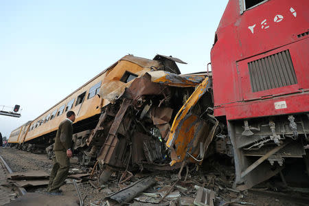 A policeman looks at the wreckage after a train crash in Kom Hamada in the northern province of Beheira, Egypt, February 28, 2018. REUTERS/Mohamed Abd El Ghany