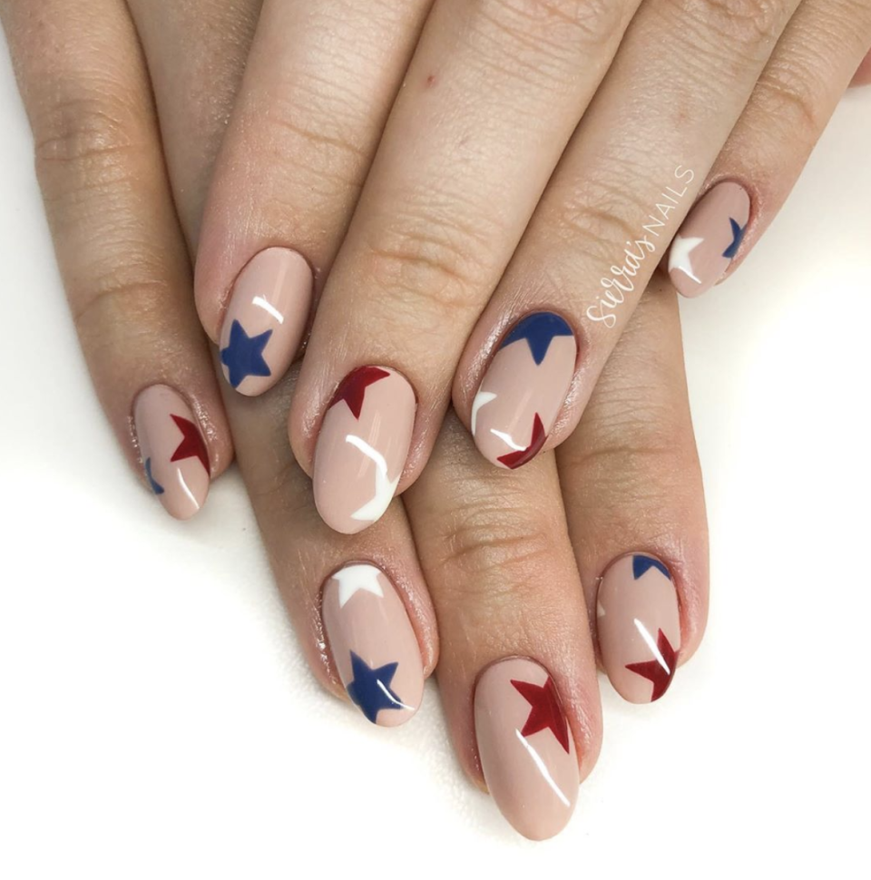 <p>For a more understated look that's just as festive as the full-on red, white, and blue ones, try stars in deep shades of red and blue over a nude mani. </p><p><a class="link " href="https://go.redirectingat.com?id=74968X1596630&url=https%3A%2F%2Fwww.ulta.com%2Fnail-lacquer-nail-polish-nudesneutrals%3FproductId%3Dpimprod2009004%26sku%3D2112430%26cmpid%3DPS_Non%2521google%2521Product_Listing_Ads%26cagpspn%3Dpla%26CATCI%3Dpla-294680686006%26CAAGID%3D18002902230%26CAWELAID%3D1888492544%26CATARGETID%3D330000200001332369%26cadevice%3Dc%26gclid%3DCj0KCQjwzZj2BRDVARIsABs3l9I2rE_wF-E2bphOSTjPyumr11TiZ-E1Il_RLDDlR8kCXkS5W7mC0mYaAuSgEALw_wcB&sref=https%3A%2F%2Fwww.oprahdaily.com%2Fbeauty%2Fg27727694%2Ffourth-of-july-nail-ideas%2F" rel="nofollow noopener" target="_blank" data-ylk="slk:SHOP POLISH;elm:context_link;itc:0;sec:content-canvas">SHOP POLISH</a></p>