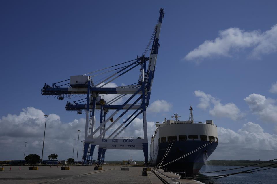 A ship carrying motor vehicles is seen berthed at Chinese built and operates Hambantota International Port in Hambantota, Sri Lanka, Tuesday, Aug. 16, 2022. China has lent Sri Lanka billions of dollars for development projects, which include the Hambantota port, which Sri Lanka leased to China in 2017 because it could not pay back the loan. (AP Photo/Eranga Jayawardena)