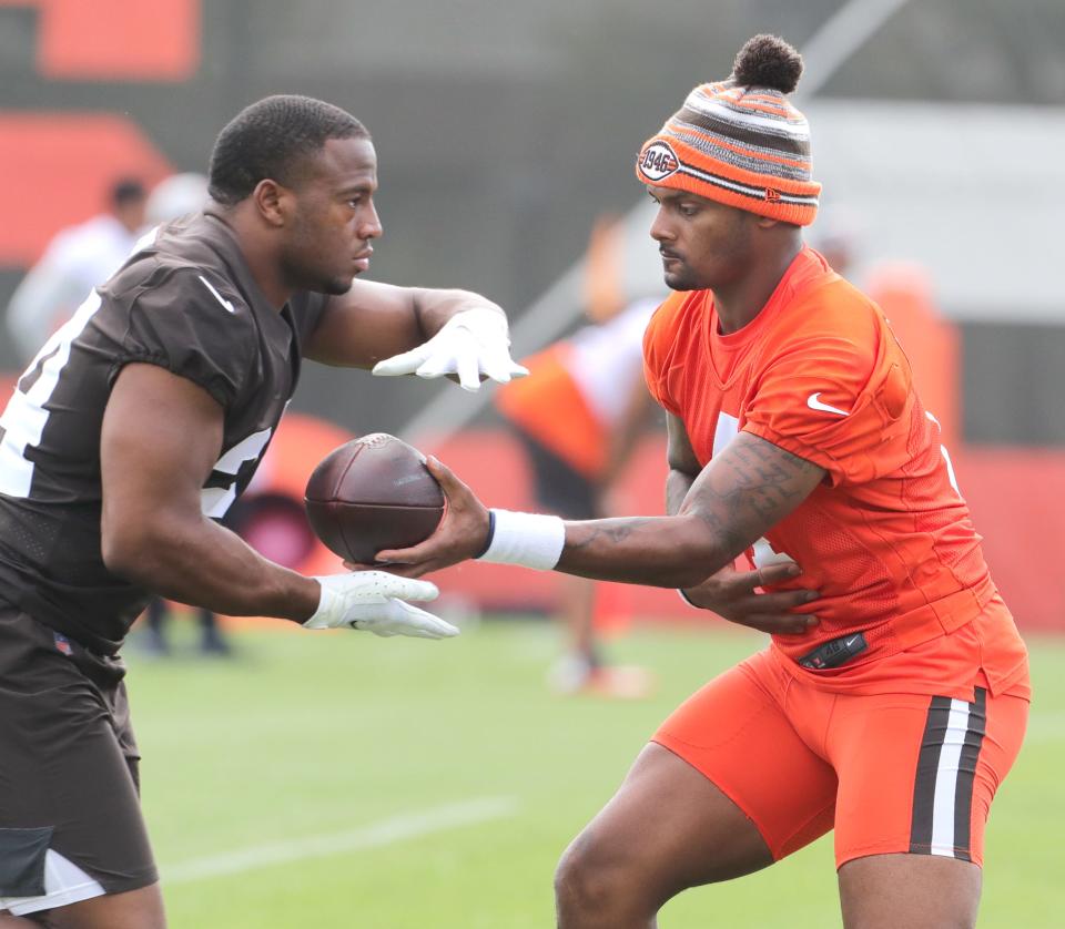 Cleveland Browns quarterback Deshaun Watson hands the ball off to Nick Chubb during OTA workouts on Wednesday, June 1, 2022 in Berea.
