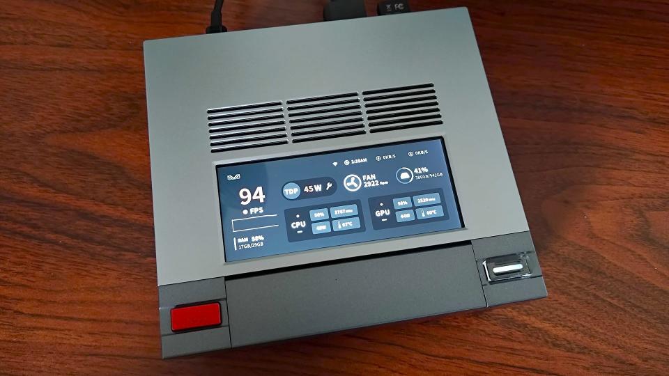 Ayaneo Mini PC AM02 with performance stats screen on display