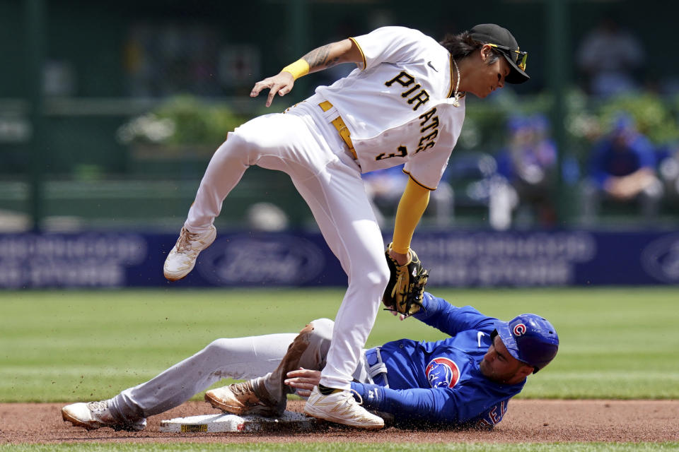 Chicago Cubs' Cody Bellinger gets safely to second base on a steal against Pittsburgh Pirates second baseman Ji Hwan Bae in the first inning of a baseball game in Pittsburgh, Sunday, Aug. 27, 2023. (AP Photo/Matt Freed)