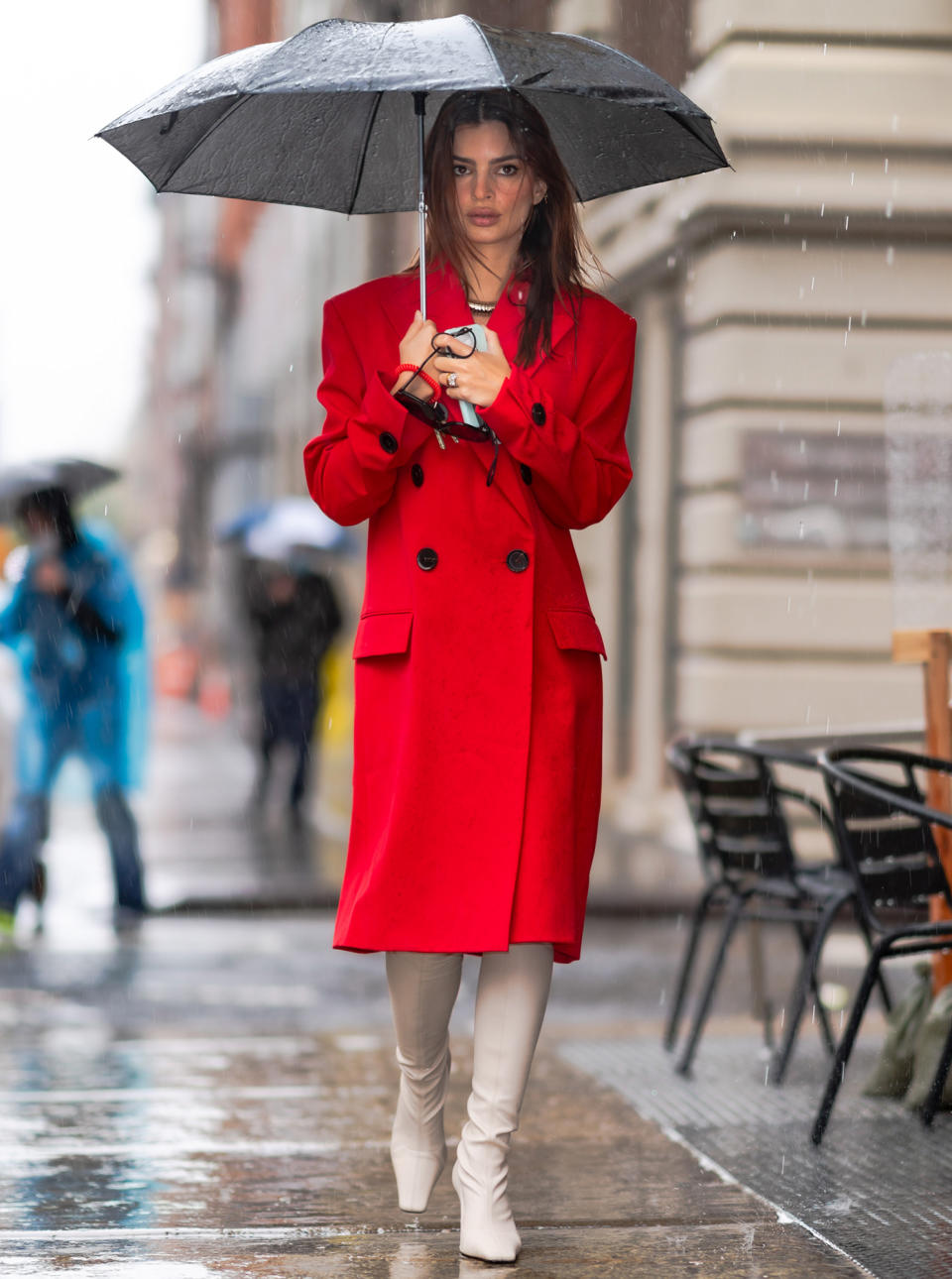 <p>Emily Ratajkowski braves the rain in an elegant red coat and white boots on Thursday in N.Y.C. </p>