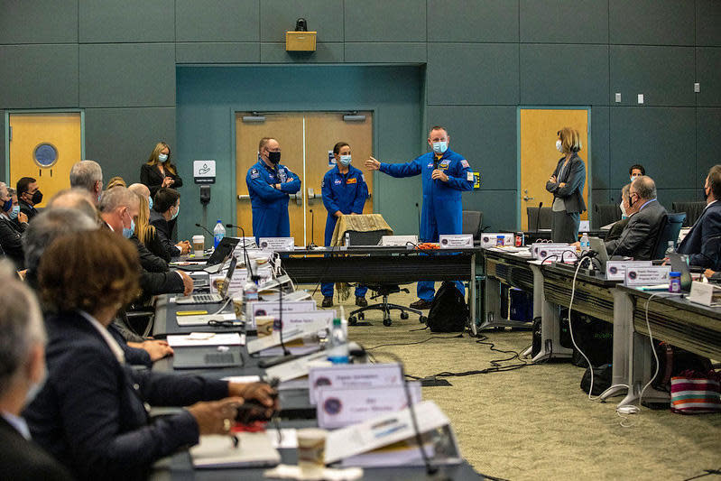 Three astronauts who will fly aboard Boeing's CST-100 Starliner spacecraft for its first crewed flight later this year met with NASA and Boeing mission managers during a flight readiness review to clear the capsule for an unpiloted test flight next week. Left to right: Michael Fincke, pilot Nicole Mann and mission commander Barry 