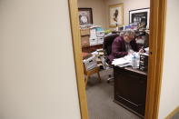 FILE - In this Dec. 1, 2019, file photo the Rev. Philip Schmitter prepares for a sermon in his office at Christ the King Catholic Church in Flint, Mich. Schmitter says many in his predominantly African-American congregation are struggling with the loss of a family member to COVID-19, along with feelings of isolation as they stay home, anxiety over the virus's toll and fear that they won't be able to make ends meet. A new poll conducted last week by NORC at the University of Chicago for the Data Foundation found that most Americans reported feeling nervous, depressed, lonely or hopeless in the last week. (AP Photo/Martha Irvine, File)