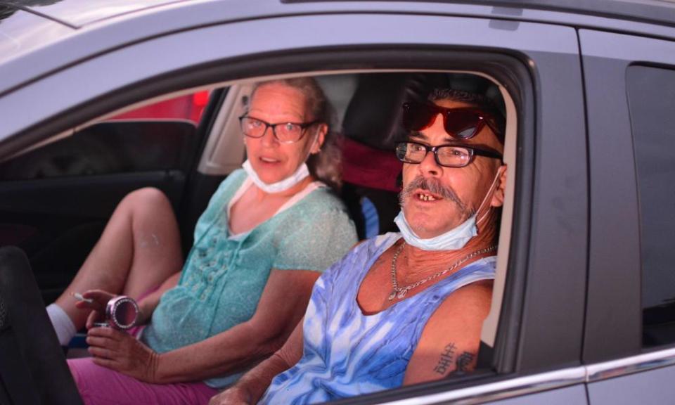 Leann Carlsen and James Virgil, local residents, wait for the movie to start in their cars at the Ocala drive-in theatre.