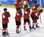 Ice Hockey - Pyeongchang 2018 Winter Olympics - Men's Playoff Match - Switzerland v Germany - Gangneung Hockey Centre, Gangneung, South Korea - February 20, 2018 - Swiss players react in line up after losing a match in overtime. REUTERS/David W Cerny