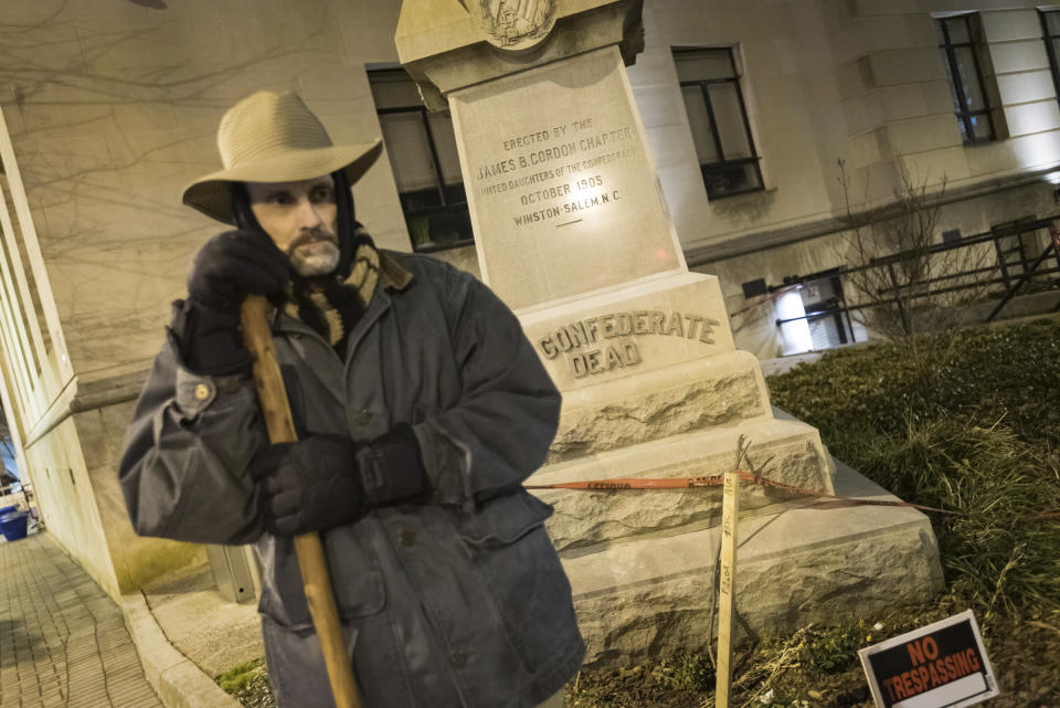 FILE - Lance Spivey, the chairman of the board of the Heirs to the Confederacy, stands outside in 20-degree weather to show his support for the Confederate monument early Friday, Feb. 1, 2019, at the corner of Fourth and Liberty streets in downtown Winston-Salem, N.C. On Friday, Dec. 16, 2022, North Carolina's Supreme Court ruled that the local chapter of United Daughters of the Confederacy lacks standing to challenge the city of Winston-Salem's removal of the Confederate monument on private property, but it can refile a future lawsuit making similar arguments. (Allison Lee Isley/The Winston-Salem Journal via AP, File)