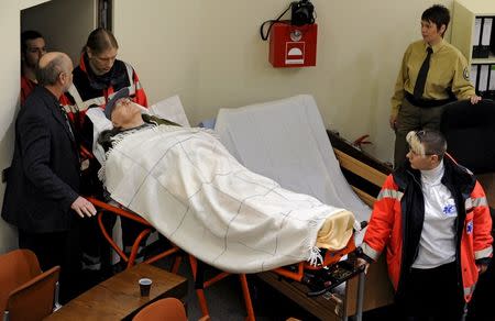 Defendant John Demjanjuk, an 89-year-old former Sobibor extermination camp guard, is brought in a courtroom in Munich, in this file picture taken December 22, 2009. REUTERS/Joerg Koch/Pool/Files