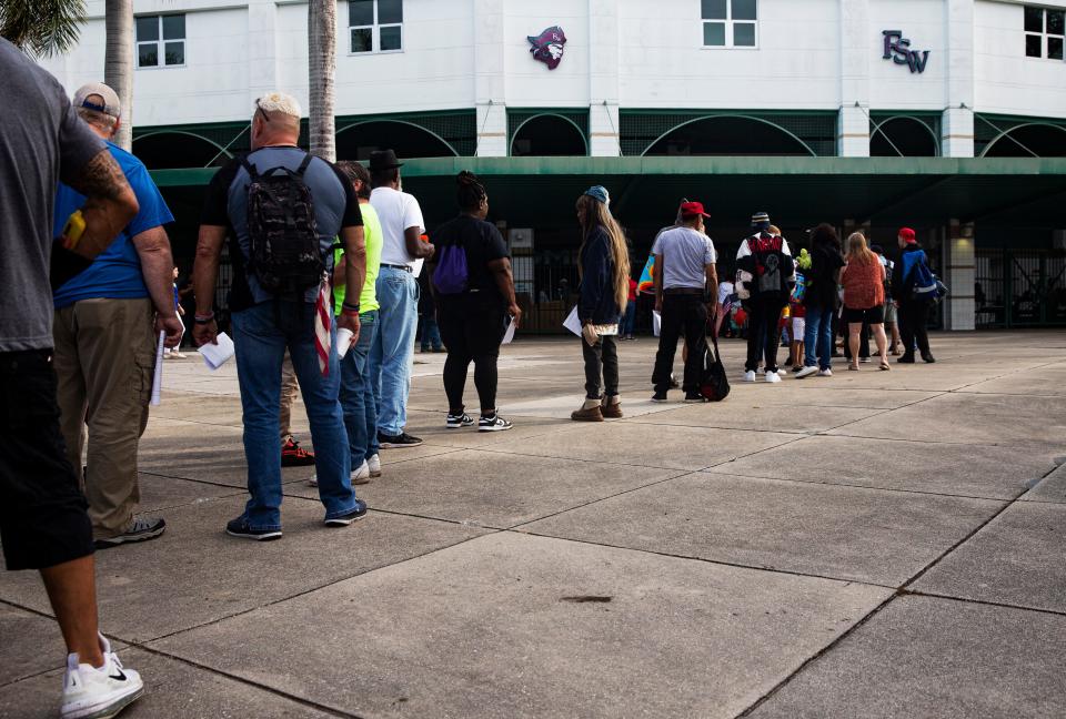 People line up for services at the SWFL Hunger and Homeless CoalitionÕs annual "point in time" homeless count at City of Palms Park in Fort Myers on Saturday, Jan. 27, 2024. Vendors were set up at the event to help the homeless which included, food, hygiene kits, clothes and other help.