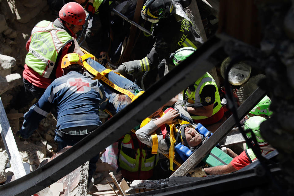 <p>A man is rescued from the rubble of a building after an earthquake, in Accumoli, central Italy, Wednesday, Aug. 24, 2016.(AP Photo/Andrew Medichini) </p>