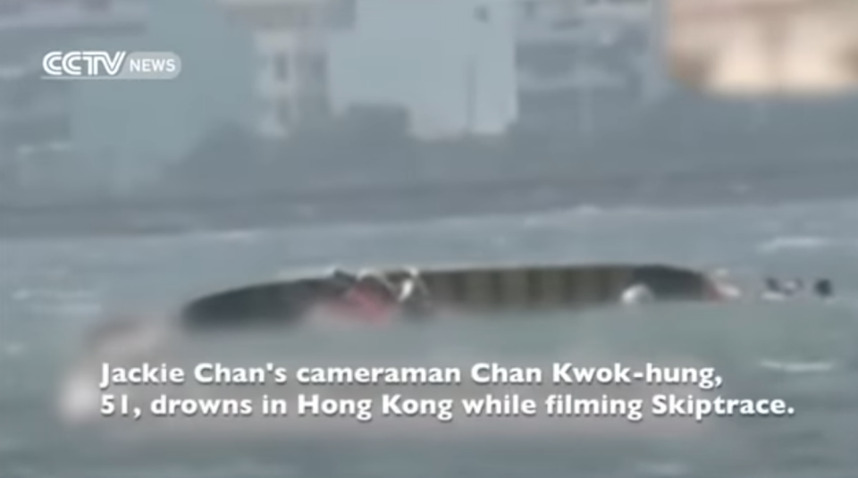 News footage of the boat that capsized on the set of "Skiptrace," with text that reads, "Jackie Chan's cameraman Chan Kwog-hung, 51, drowns in Hong Kong while filming Skiptrace."