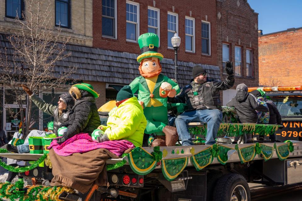 A larger-than-usual leprechaun rides a float down North Third Avenue in downtown Sturgeon Bay as part of the city's 2023 St. Patrick's Day Parade. The 2024 parade takes place March 16.