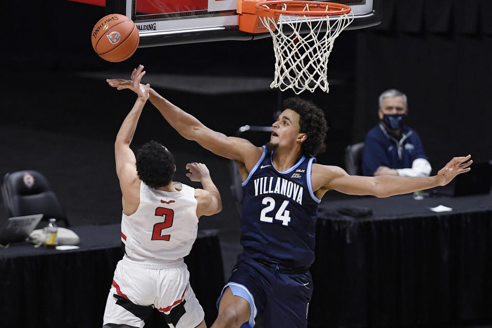 Villanova's Jeremiah Robinson-Earl (24) blocks a shot by Hartford's D.J. Mitchell (2) in the first half of an NCAA college basketball game, Tuesday, Dec. 1, 2020, in Uncasville, Conn. (AP Photo/Jessica Hill)