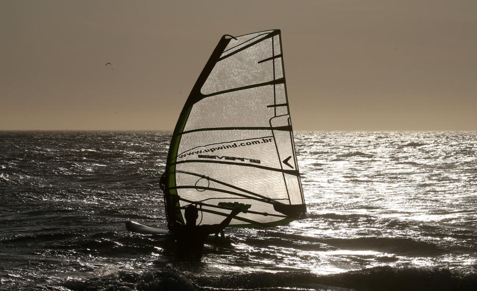A windsurfer practices on Barra da Tijuca beach