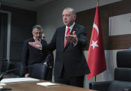 Turkey's President Recep Tayyip Erdogan speaks to the media before traveling to Azerbaijan, in Istanbul, Monday, Oct. 14, 2019. Erdogan has criticized NATO allies which are looking to broaden an arms embargo against Turkey over its push into northern Syria. (Presidential Press Service/Pool Photo via AP)