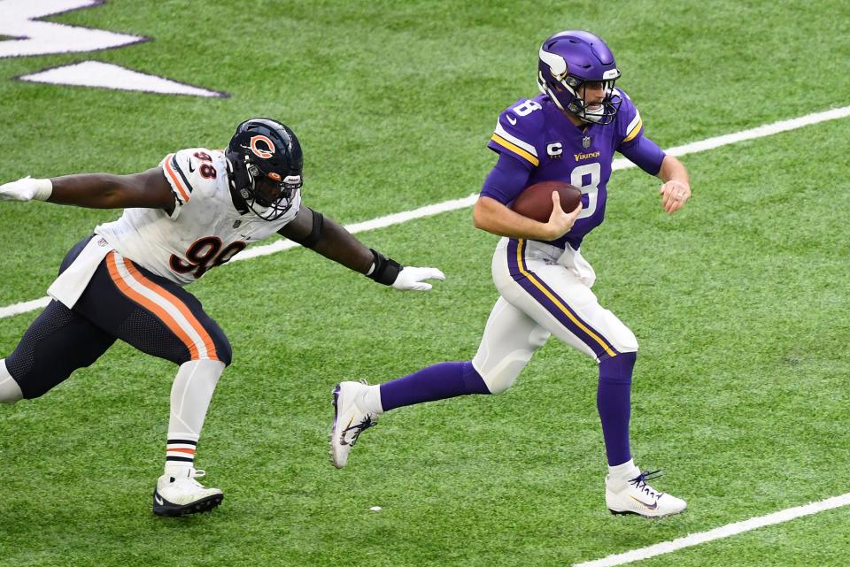 MINNEAPOLIS, MINNESOTA - DECEMBER 20: Kirk Cousins #8 of the Minnesota Vikings runs with the ball as he is pursued by Bilal Nichols #98 of the Chicago Bears during the first half at U.S. Bank Stadium on December 20, 2020 in Minneapolis, Minnesota. (Photo by Hannah Foslien/Getty Images)